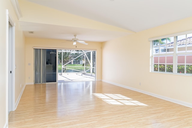 unfurnished room featuring ceiling fan, lofted ceiling, and light wood-type flooring