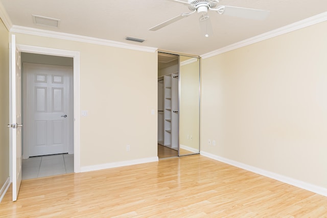 spare room featuring ceiling fan, light hardwood / wood-style floors, and crown molding