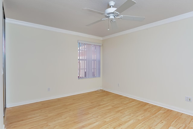 spare room featuring light hardwood / wood-style flooring, ceiling fan, and ornamental molding