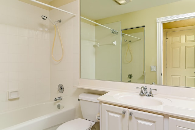 full bathroom with vanity, toilet, and tiled shower / bath