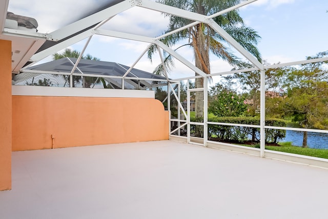 unfurnished sunroom with a water view and a wealth of natural light