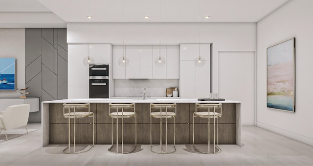 kitchen featuring stainless steel oven, sink, a center island with sink, white cabinets, and black oven