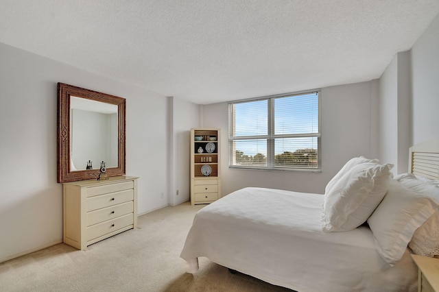 carpeted bedroom featuring a textured ceiling