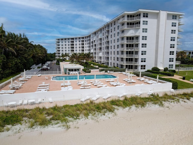 view of property with a water view and a community pool