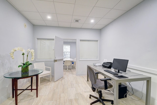 home office featuring a paneled ceiling and light hardwood / wood-style floors