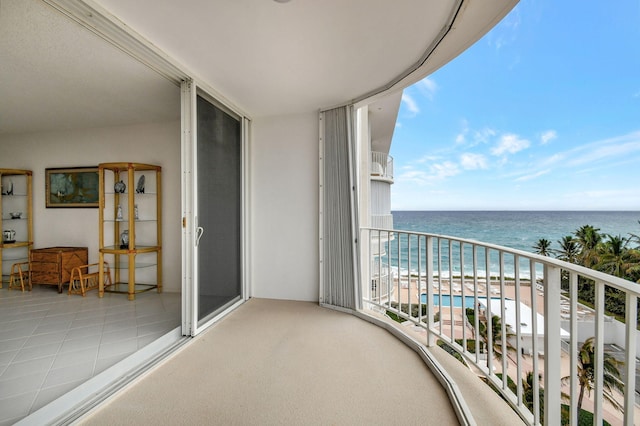 balcony with a water view and a beach view