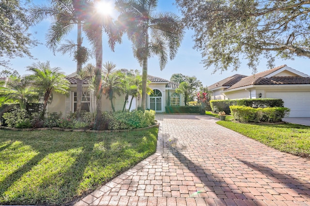 mediterranean / spanish-style home with a garage and a front yard