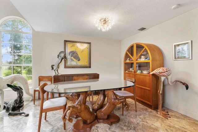 dining area with a textured ceiling