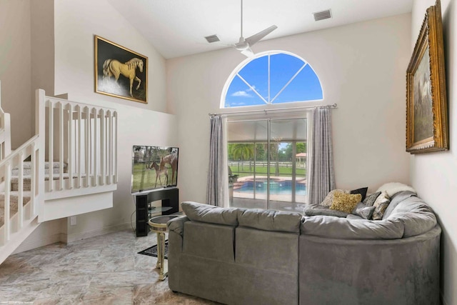 living room featuring ceiling fan and high vaulted ceiling