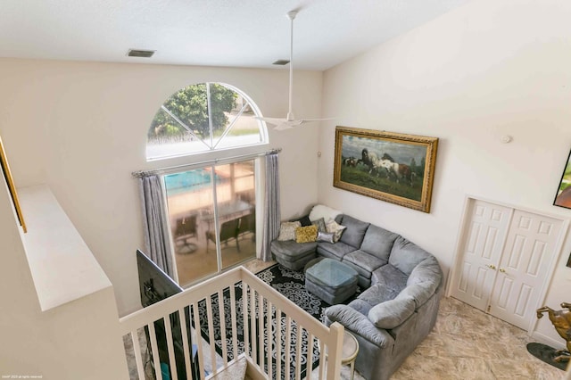 living room featuring high vaulted ceiling