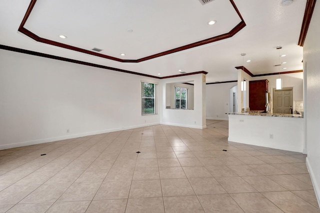 unfurnished living room featuring a tray ceiling, light tile patterned flooring, and ornamental molding