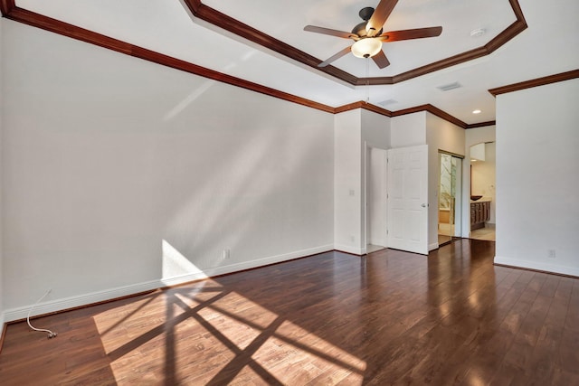 unfurnished living room with a raised ceiling, ceiling fan, dark hardwood / wood-style flooring, and ornamental molding