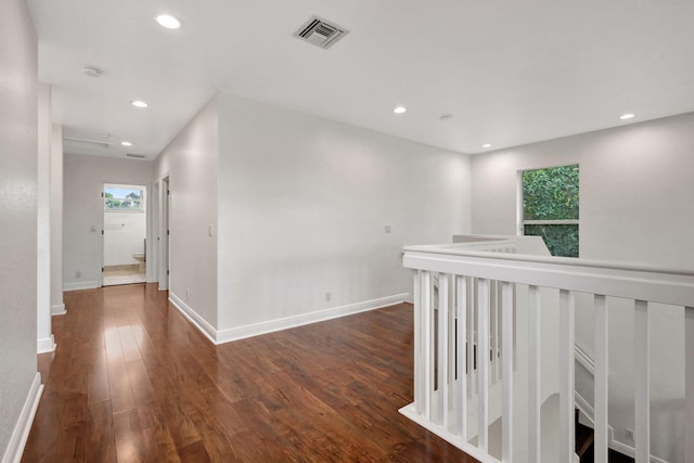 hall featuring dark hardwood / wood-style flooring and a healthy amount of sunlight