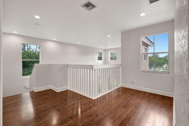 unfurnished room with dark hardwood / wood-style flooring