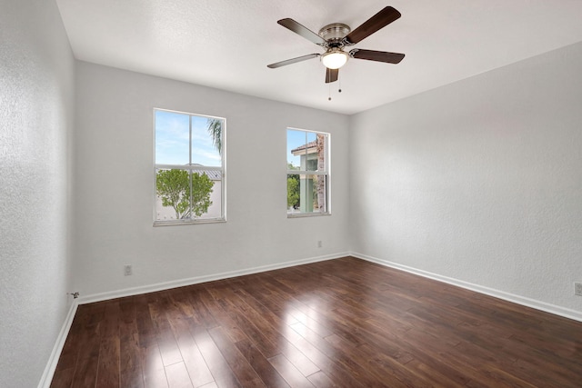 spare room featuring dark hardwood / wood-style flooring and ceiling fan