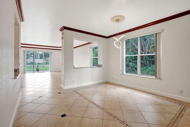 spare room featuring light tile patterned floors, crown molding, and a healthy amount of sunlight