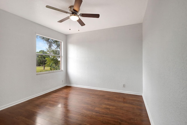 unfurnished room with ceiling fan and dark wood-type flooring