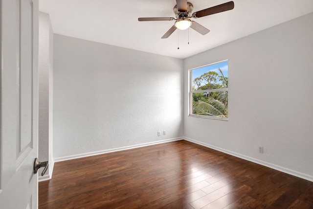 empty room featuring dark hardwood / wood-style floors and ceiling fan