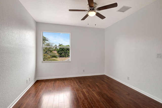 spare room with ceiling fan and dark wood-type flooring