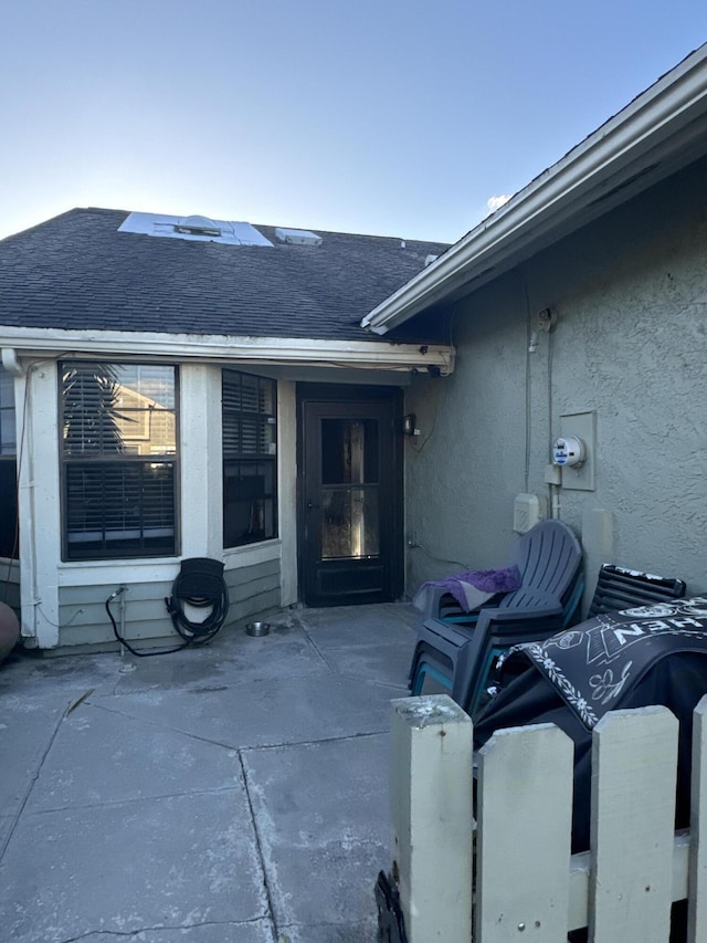 property entrance featuring a patio area