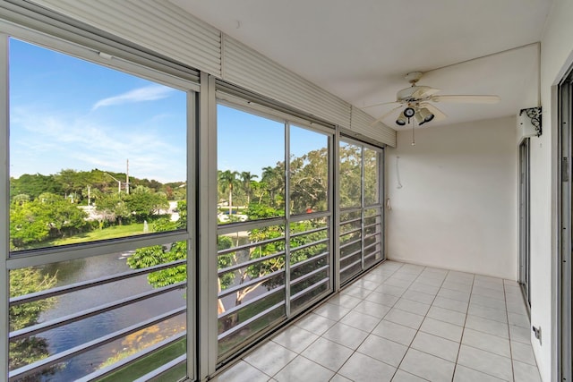 unfurnished sunroom featuring ceiling fan