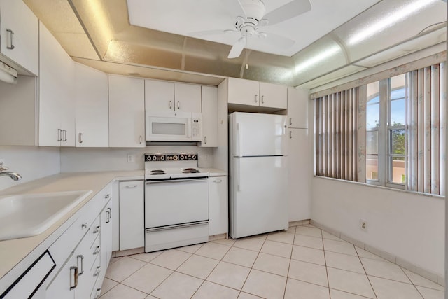 kitchen with white appliances, sink, ceiling fan, light tile patterned floors, and white cabinetry