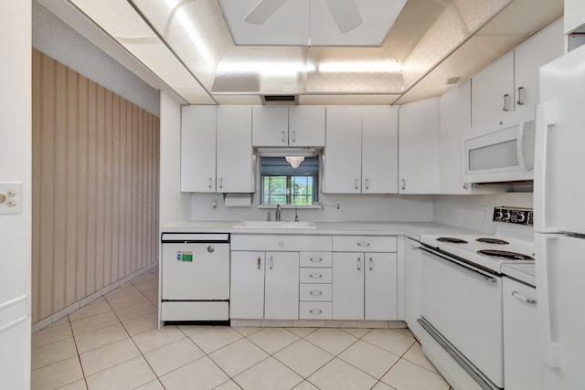 kitchen featuring light tile patterned floors, white appliances, white cabinetry, and sink