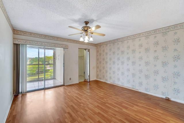 empty room featuring ceiling fan, light hardwood / wood-style floors, and a textured ceiling