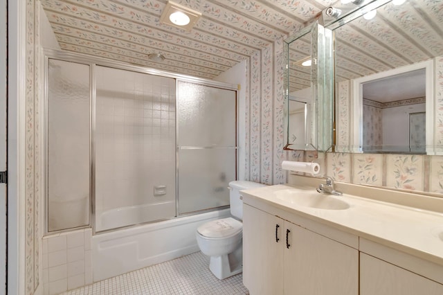 full bathroom featuring tile patterned flooring, vanity, toilet, and shower / bath combination with glass door