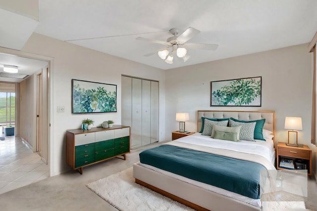 bedroom with ceiling fan, a closet, and light tile patterned flooring