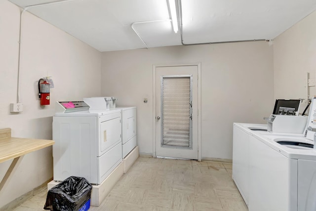 laundry room with light parquet flooring and separate washer and dryer