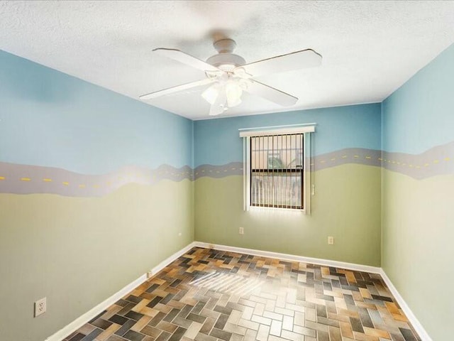 spare room featuring ceiling fan and a textured ceiling