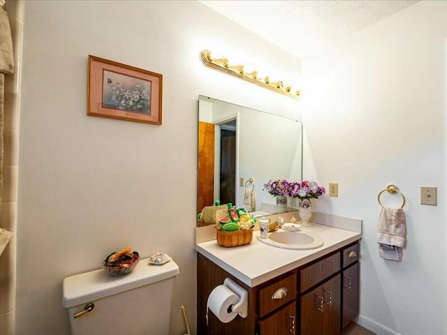 bathroom featuring toilet and vanity