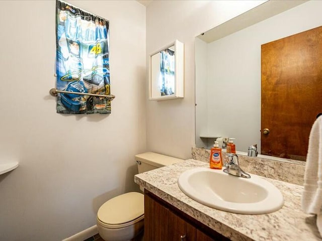 bathroom with toilet and vanity