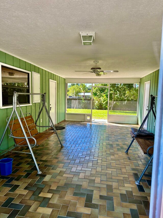 exterior space with a playground and ceiling fan