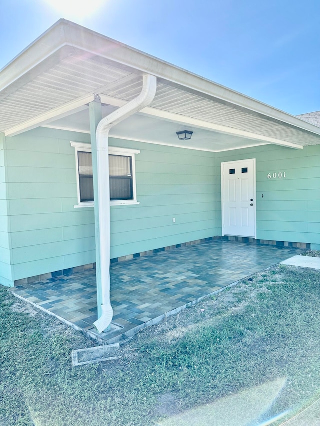 doorway to property with a carport