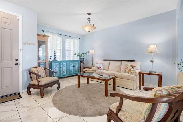 living room featuring baseboards and marble finish floor