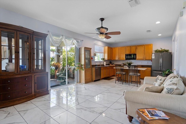 kitchen featuring visible vents, dark countertops, appliances with stainless steel finishes, and ceiling fan