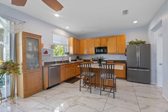 kitchen featuring a breakfast bar area, visible vents, recessed lighting, stainless steel appliances, and marble finish floor