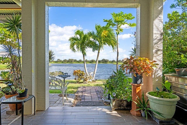 balcony featuring a patio area and a water view