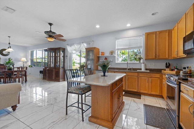 kitchen with stainless steel electric range oven, a ceiling fan, visible vents, a sink, and marble finish floor