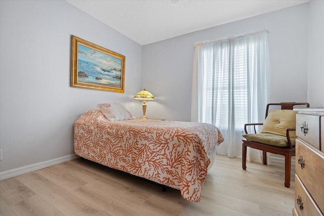 bedroom featuring baseboards and light wood-style flooring