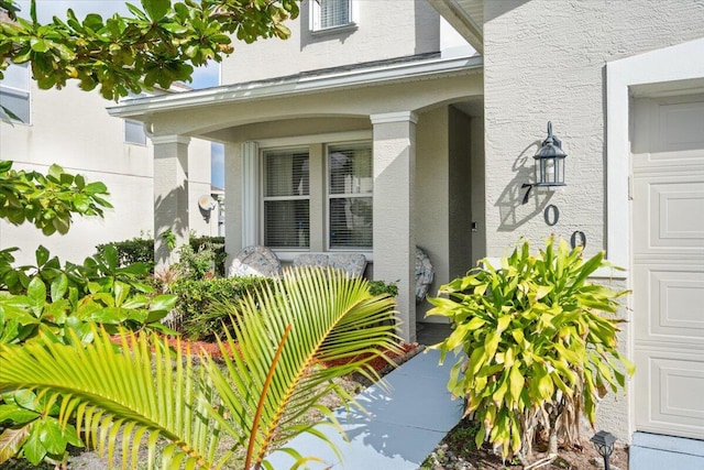 property entrance featuring stucco siding