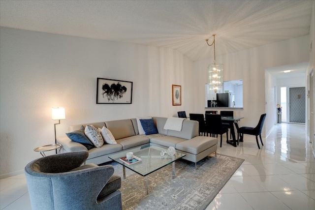 tiled living room featuring a textured ceiling and an inviting chandelier