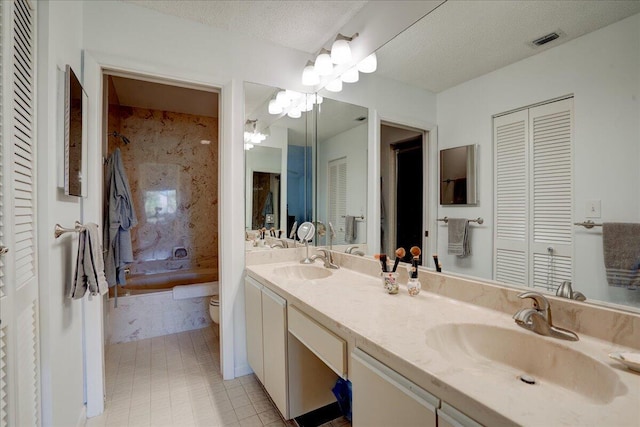 bathroom featuring vanity, tile patterned floors, a textured ceiling, and toilet