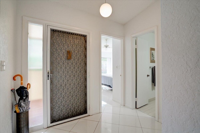 hallway featuring light tile patterned flooring