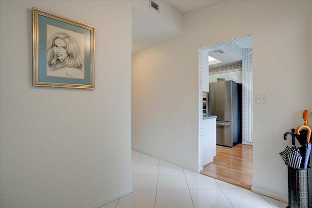 corridor with light tile patterned floors