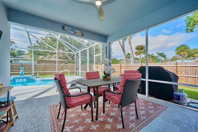 sunroom featuring ceiling fan