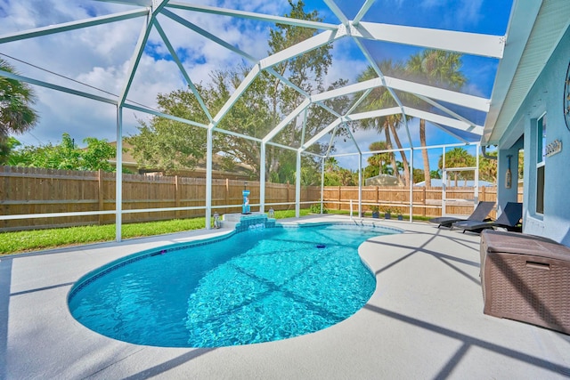 view of swimming pool featuring a lanai and a patio area