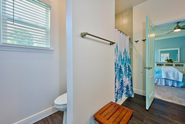 bathroom with hardwood / wood-style floors, ceiling fan, curtained shower, and toilet